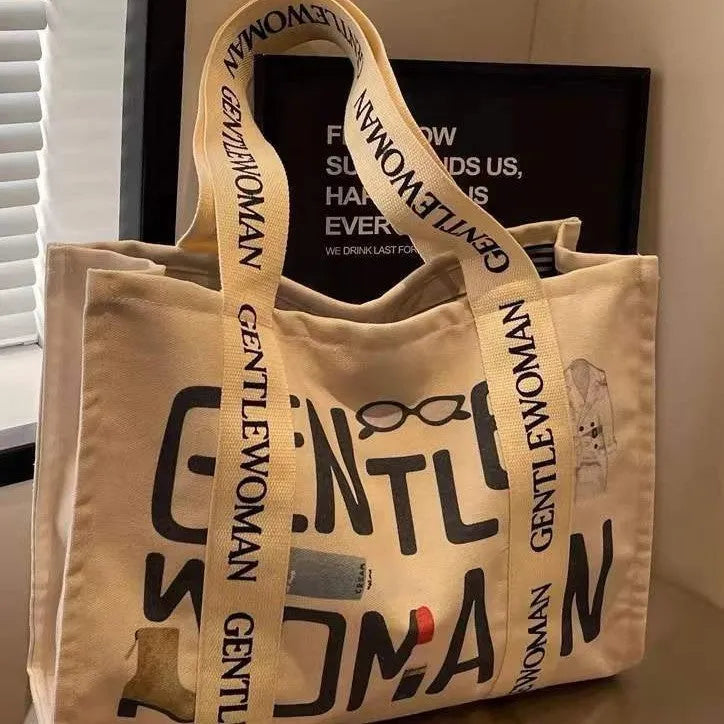 Canvas women's tote bag with printed letter or pattern designs and shoulder straps