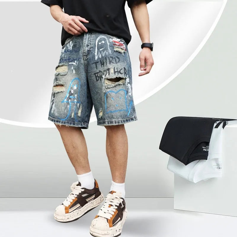 Blue ripped men's denim shorts with graffiti detail and a straight leg.