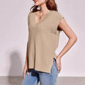 Women's camel and white v-neck sleeveless vest with loose fit and striped or plaid patterns