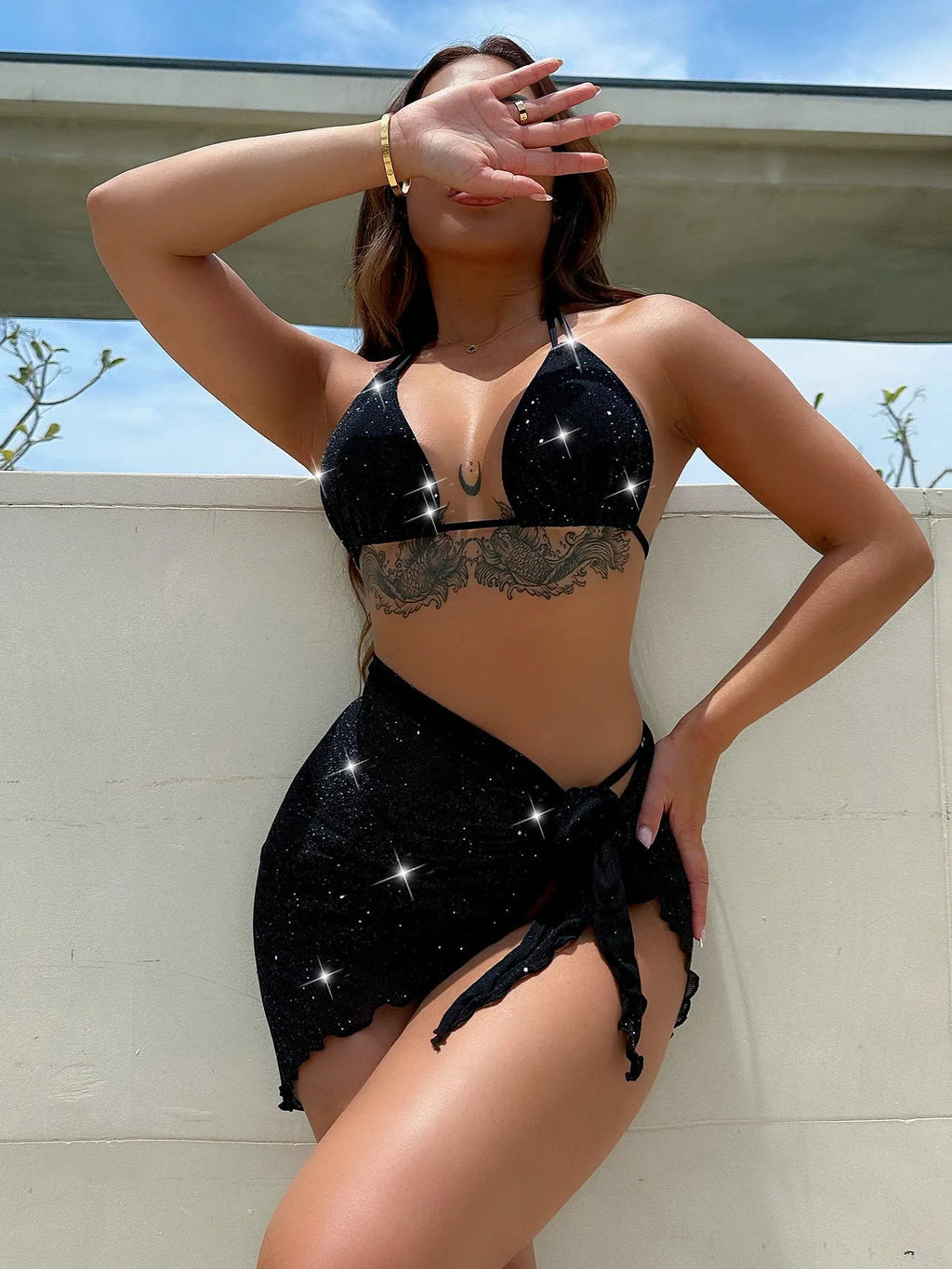 Black three-piece bikini swimsuit set with crop top and shorts on a mannequin.