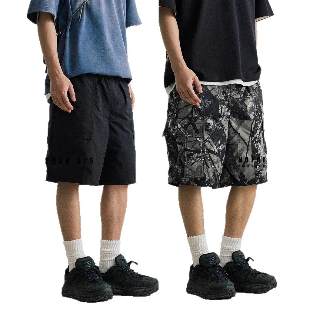 Straight-leg denim shorts in black or army green with mid-waist design and zip fly