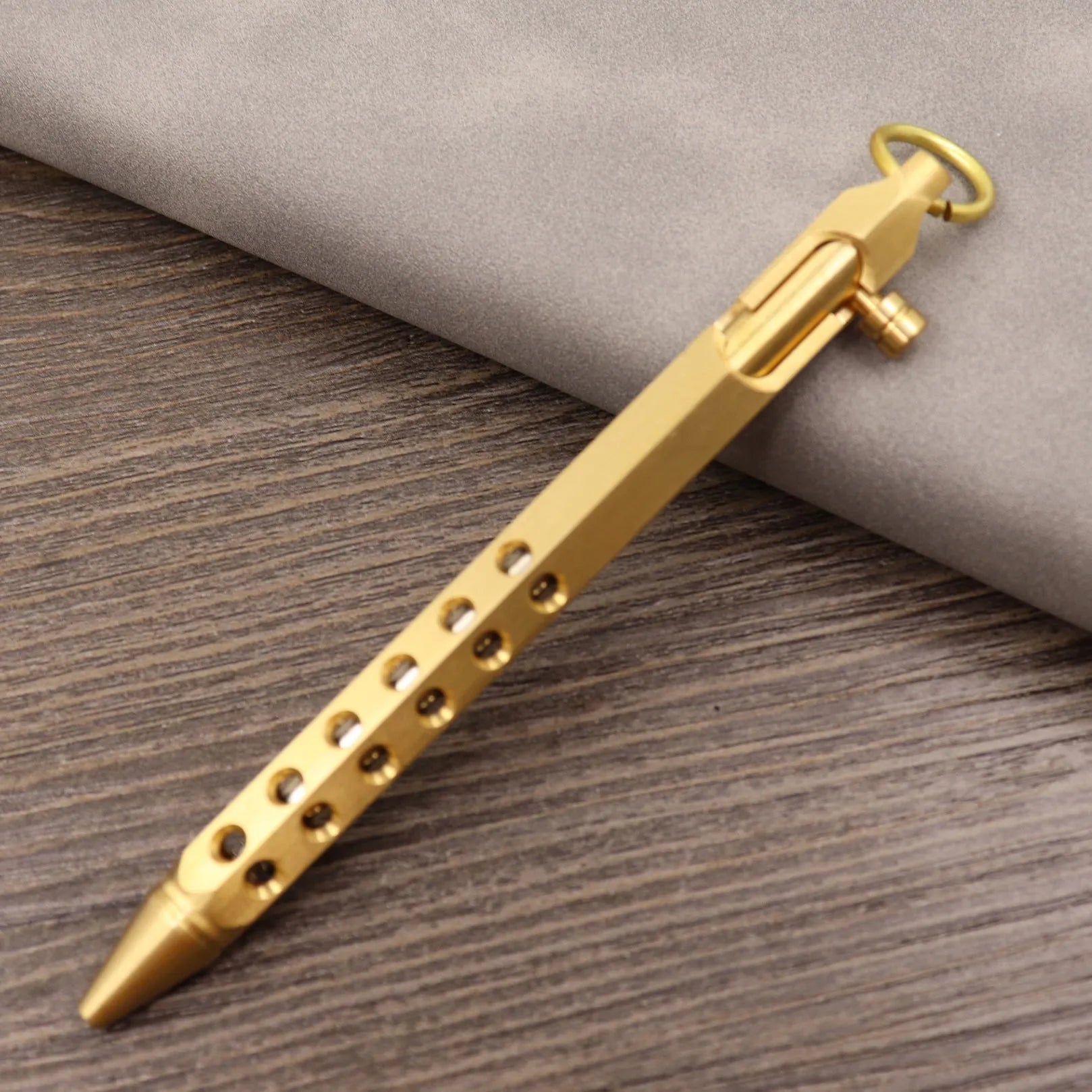 Retro brass tactical pen with bolt action mechanism in brushed natural finish