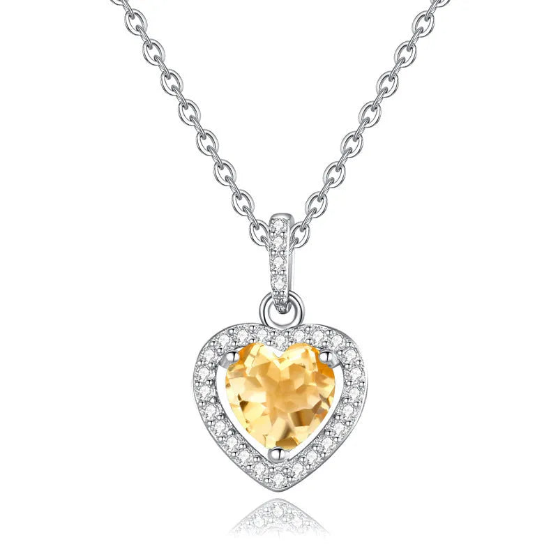 Heart-shaped sterling silver pendant necklace with a natural gemstone on an adjustable chain.