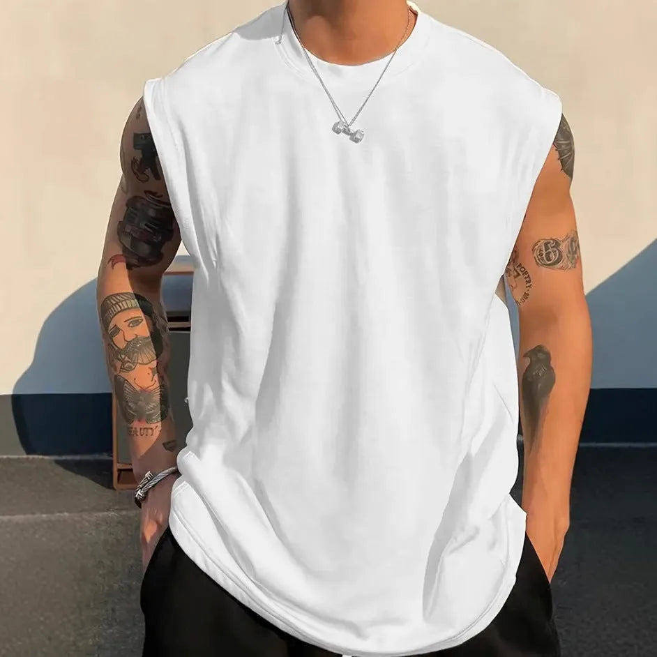 Men's solid colour loose fit cotton tank top on a hanger, showing straight hem and sleeveless design.