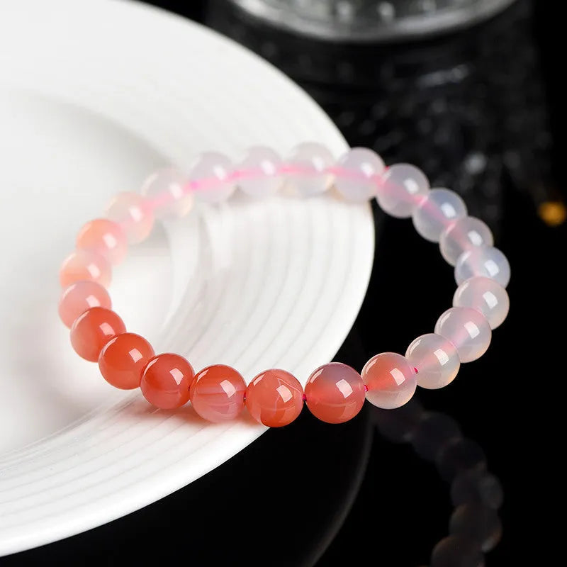 Natural gradient Yanyuan agate bracelet with geometric beads in salt source colour on a wrist.