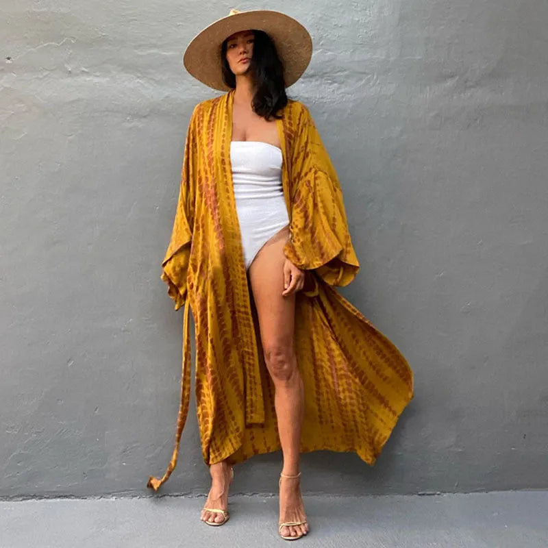 Loose-fitting cotton beach cover-up blouse in a printed pattern, shown in a rust red colour.