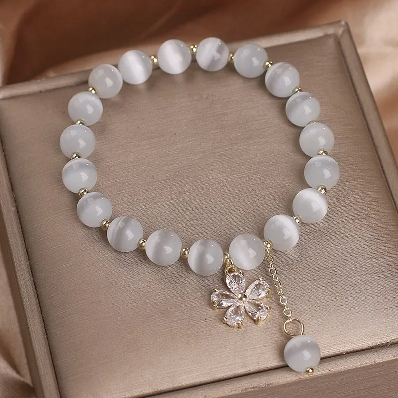 Women's white cat's eye crystal bracelet with flower tassel and morganite safety buckle pendant