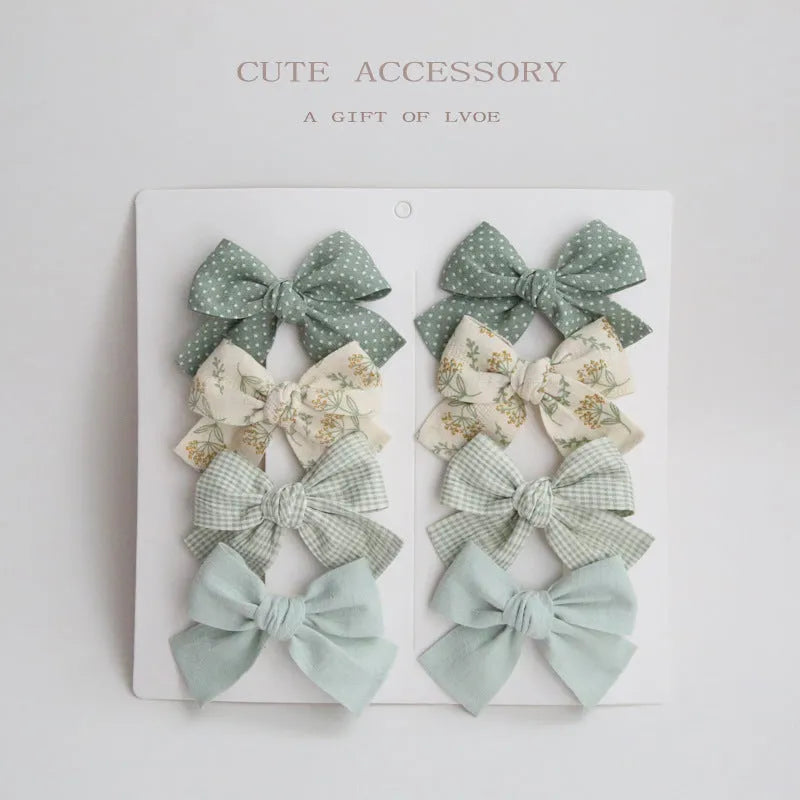 Children's fabric bow hairclips set showing dovetail design in multiple colour options