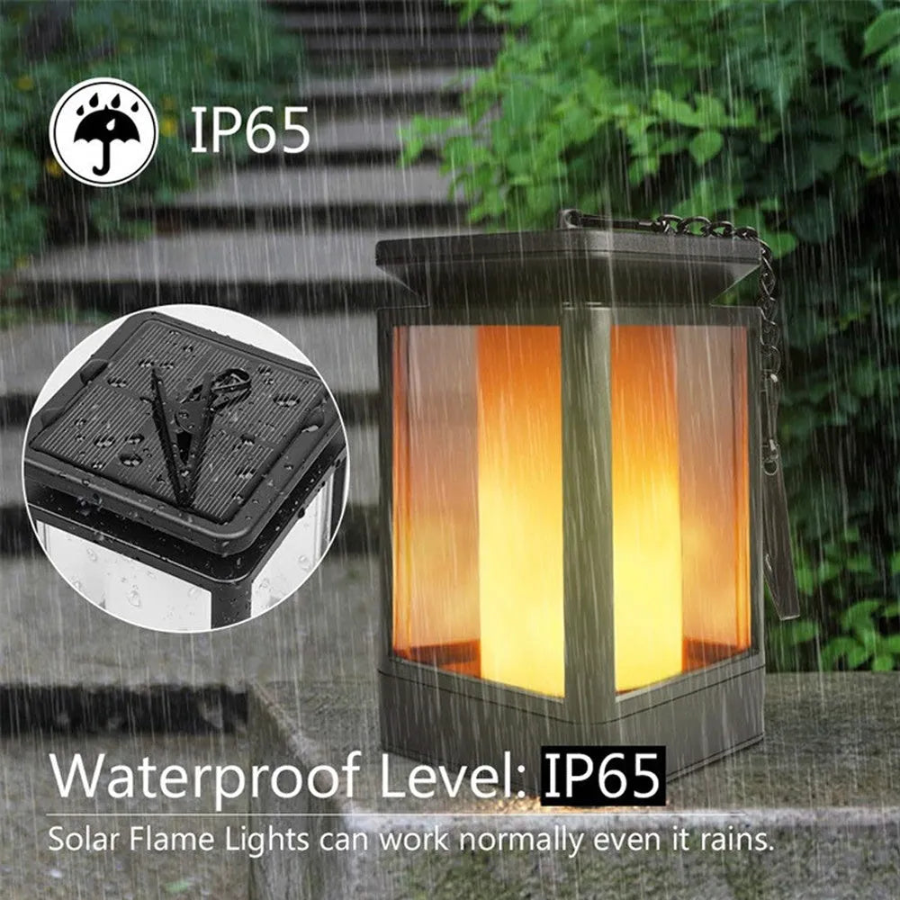 Black antique flame-shaped solar LED garden light with solar panel on top for outdoor pathway illumination