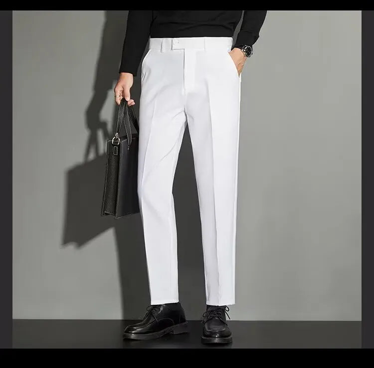 Man wearing straight-leg suit trousers with an ankle-length draping effect in a light colour.