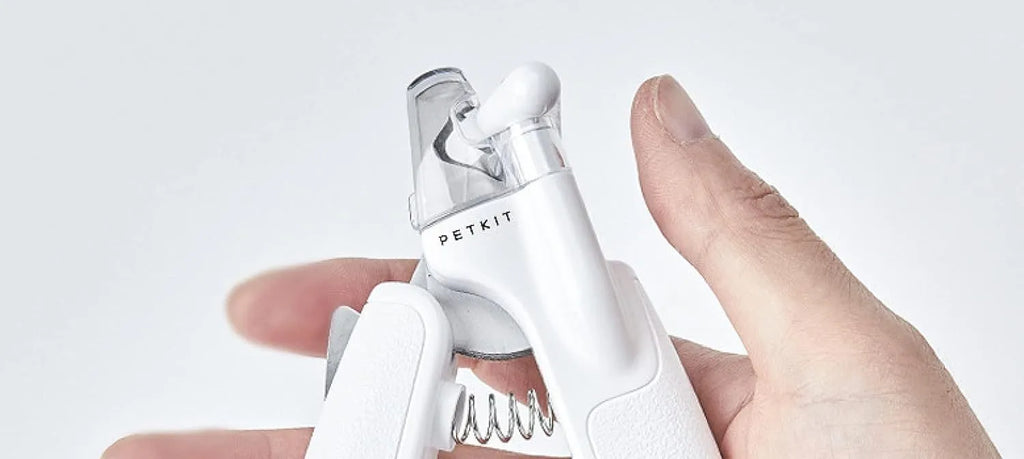 White LED pet nail clippers with open anti-splash guard and nail file on a solid colour background