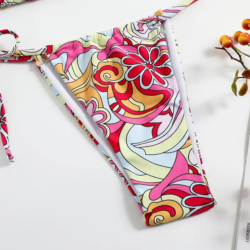 Multicolour printed women's triangle bikini set with hanging neck top and separate bottoms.
