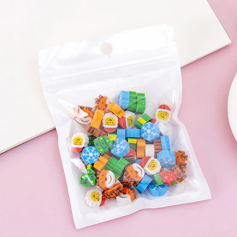 50 colourful cartoon mini erasers in shapes of fruits, animals, and cakes, displayed next to a pearlescent film bag.