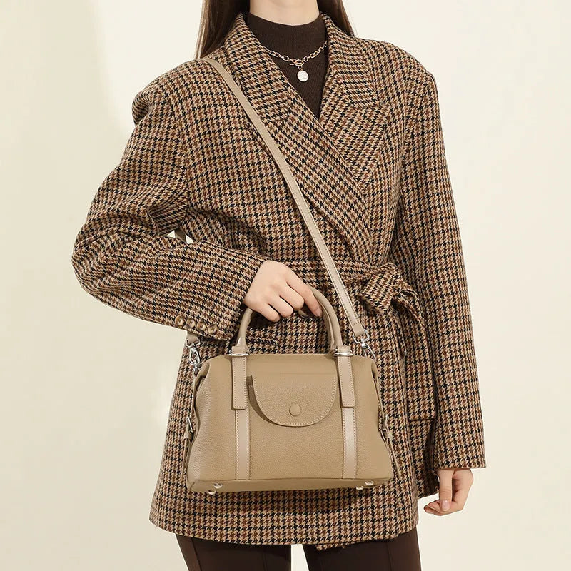 Genuine leather ladies handbag with contrast stitching and lock detail in street style