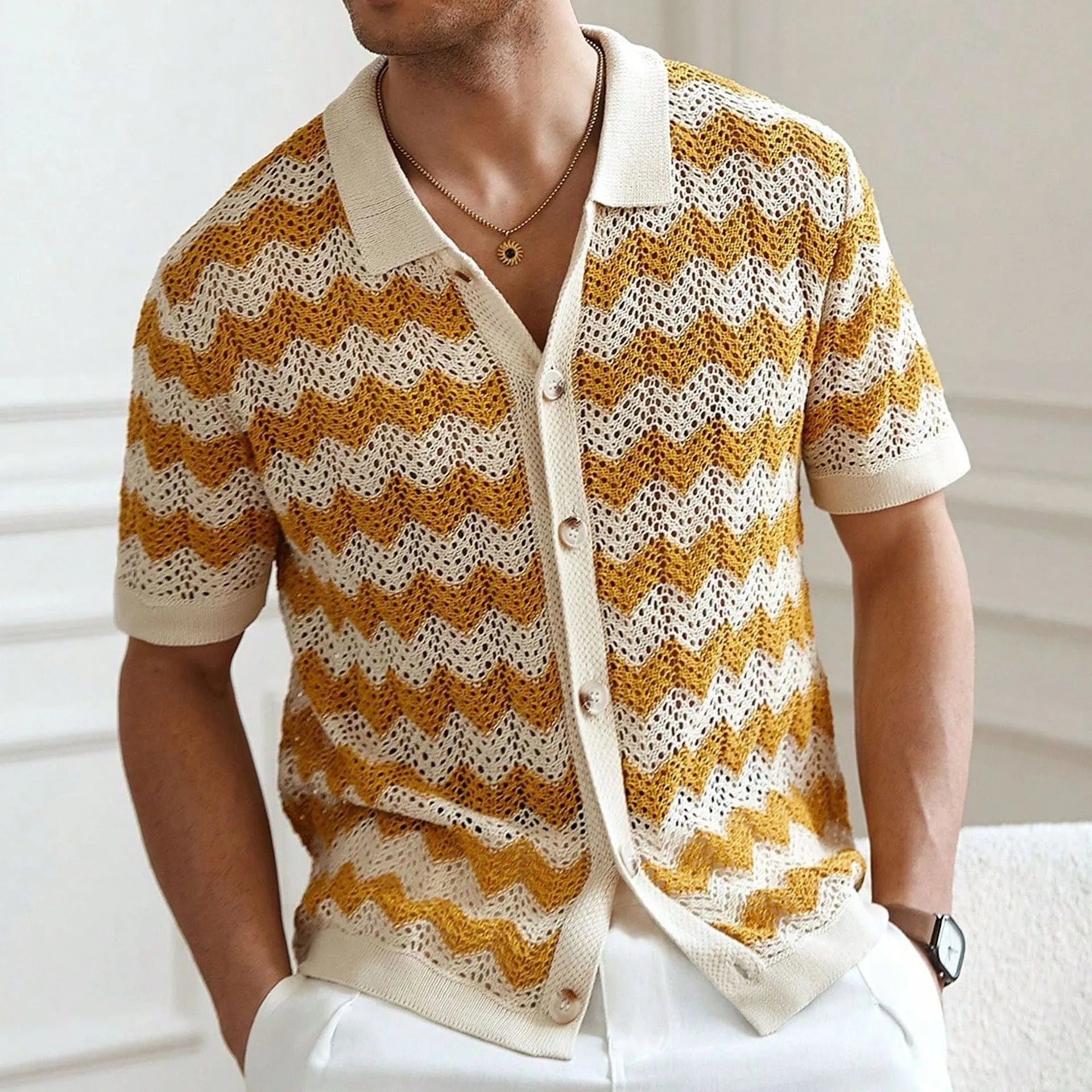 Short-sleeved yellow hollow jacquard corrugated sweater with flocked detail on a mannequin.