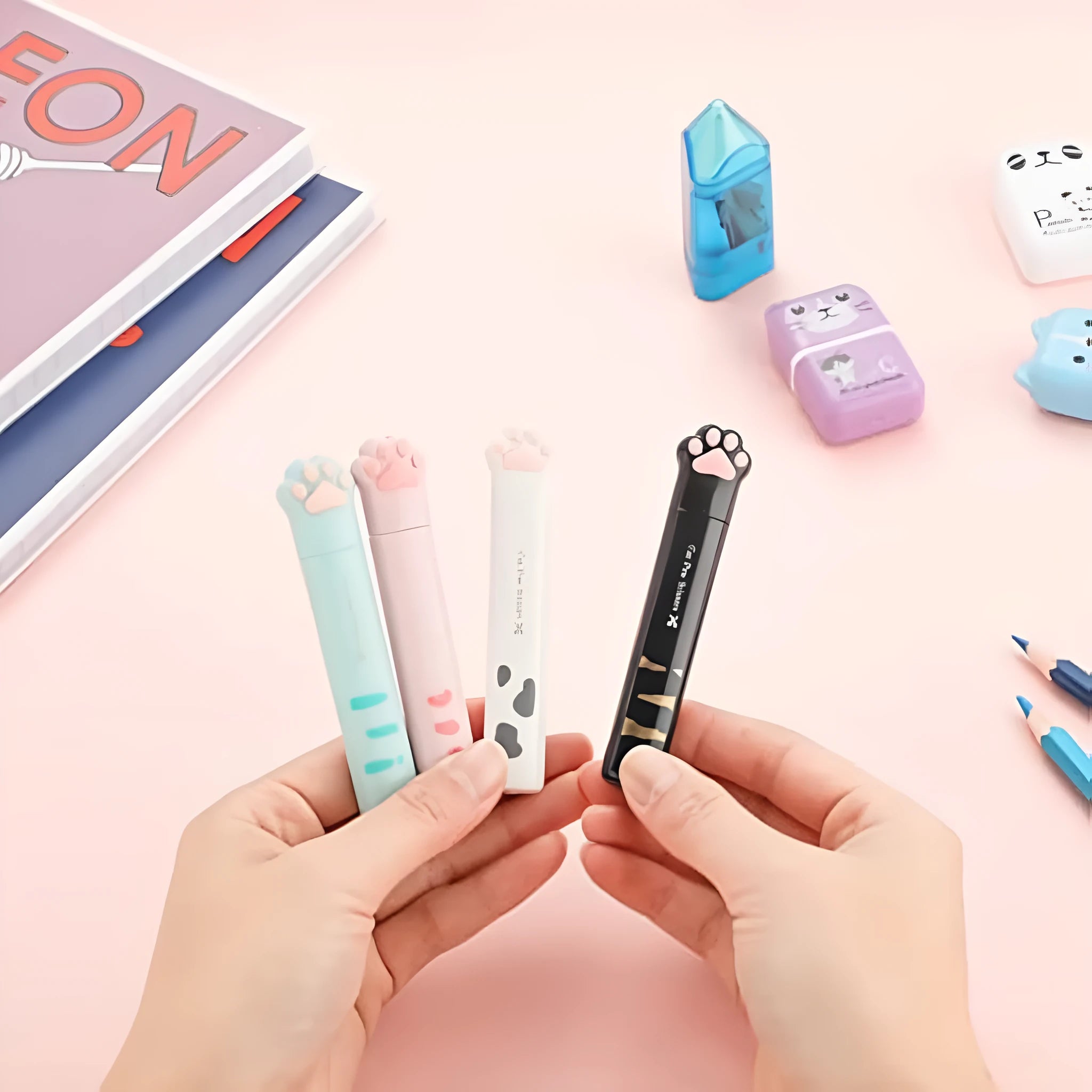 Folded cat paw mini scissors in stainless steel and plastic available in pink blue black and white colours measuring 8.7cm