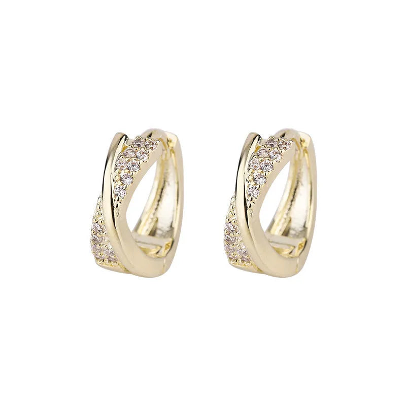 A pair of geometric drop earrings made from copper with zircon detailing and a 14K yellow finish.