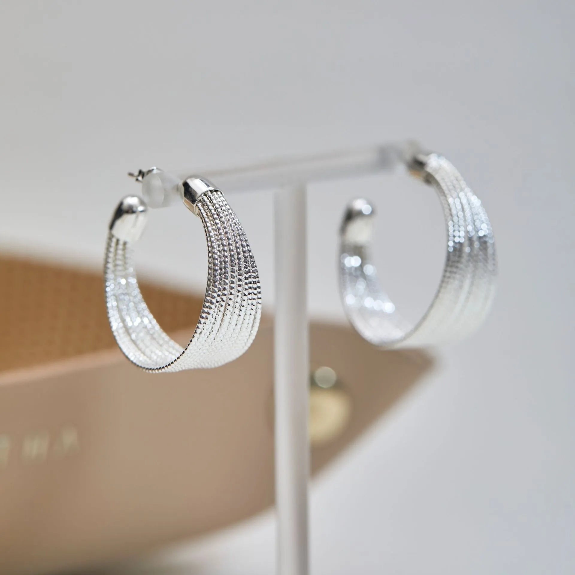 Geometric copper earrings with electroplated silver and gold finishes, including stud and clip-on options