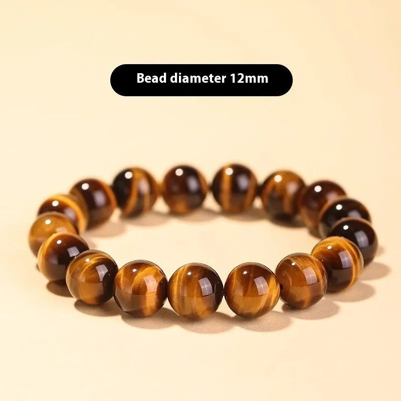 Close-up of a single-circle beaded Buddha rosary bracelet with tigereye dzi patterns on brown beads.