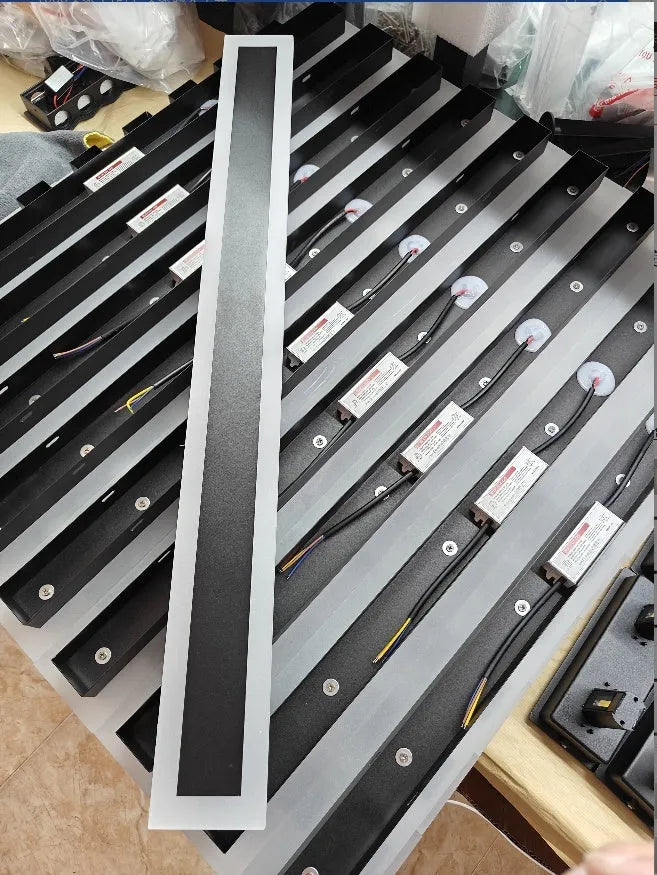 150cm long straight outdoor LED wall lamp with wrought iron housing, shown mounted on an exterior wall.