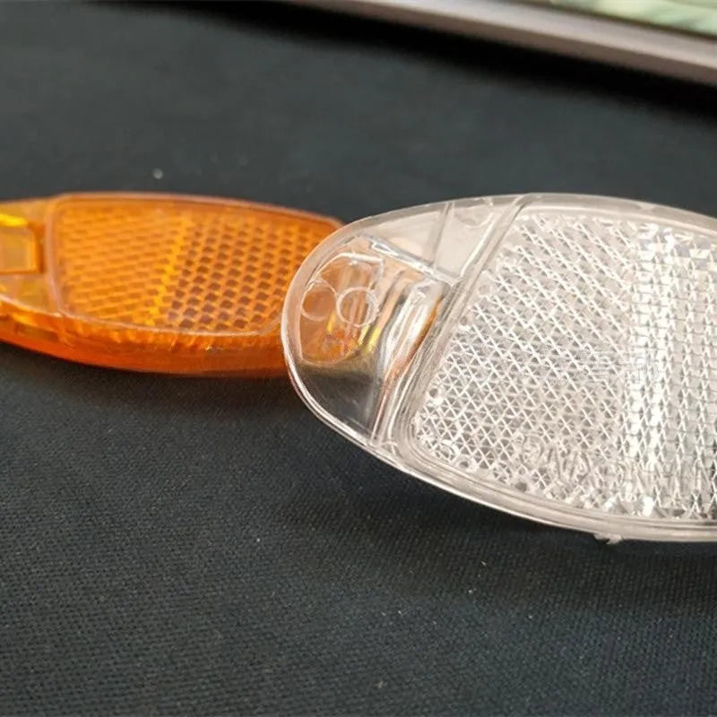 Bicycle spoke reflector set showing four plastic units in yellow colour with dimensions 7.2cm by 3.5cm