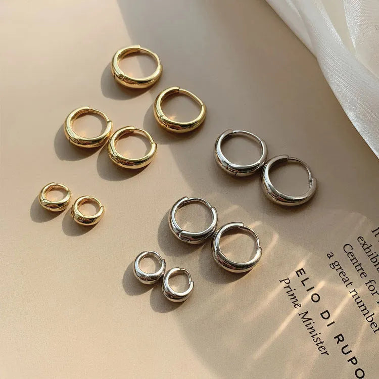 Geometric water drop earrings in gold or silver on a white background, showing small, medium, and large sizes.
