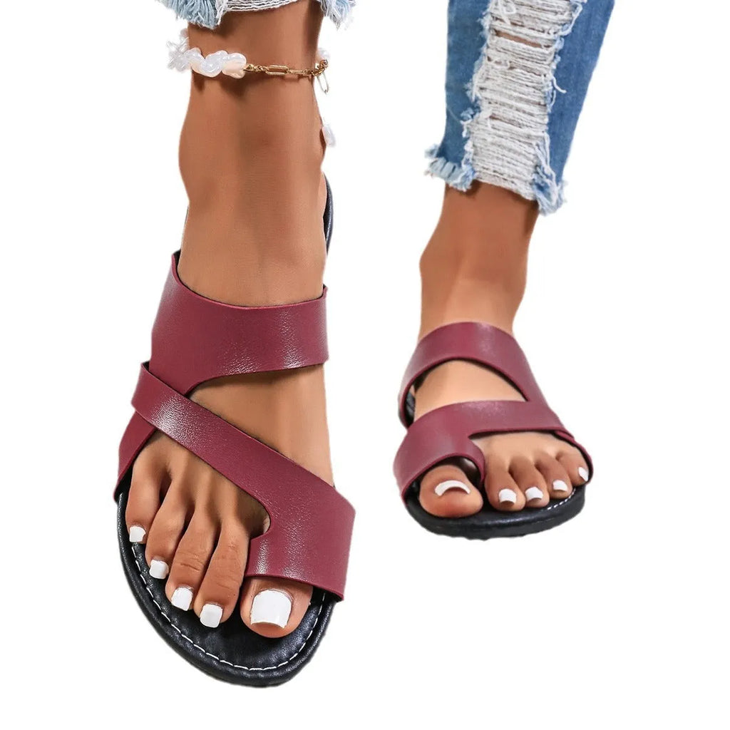 Adult round-head beach slippers in black with a one-line design, hollow-out pattern, and rubber sole.