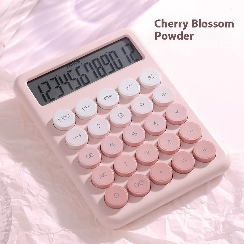 Dopamine gradient colour desk calculator in violet, pink, blue, and mint green on a desk.