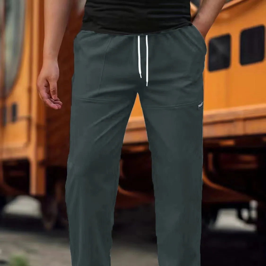 Men's lightweight polyester casual trousers in light grey colour shown flat