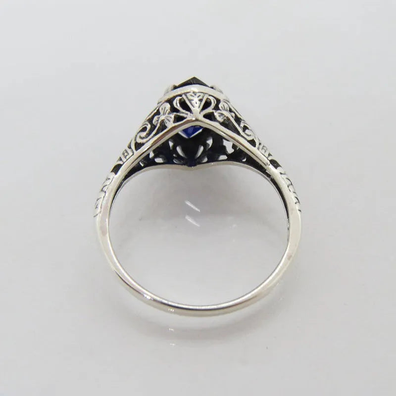 Women's silver geometric hollow ring showing alloy construction and detailed pattern