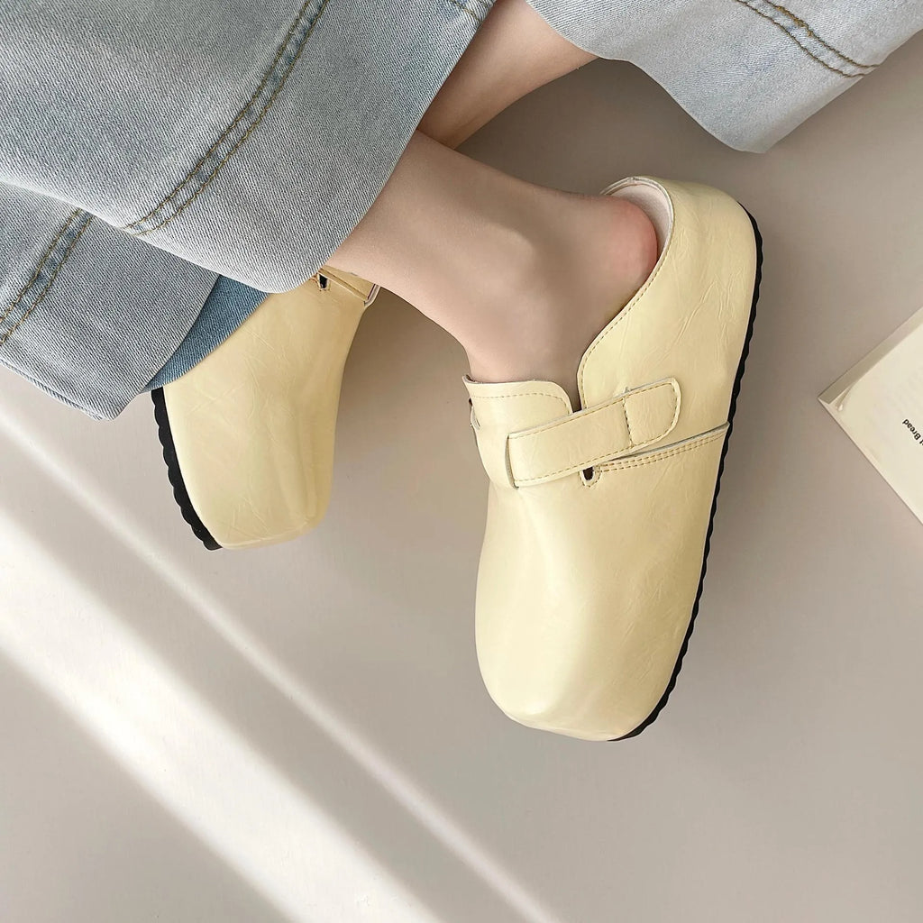 Flat buckle casual sneakers in yellow, black, silver, and creamy-white colours with rounded toe shape