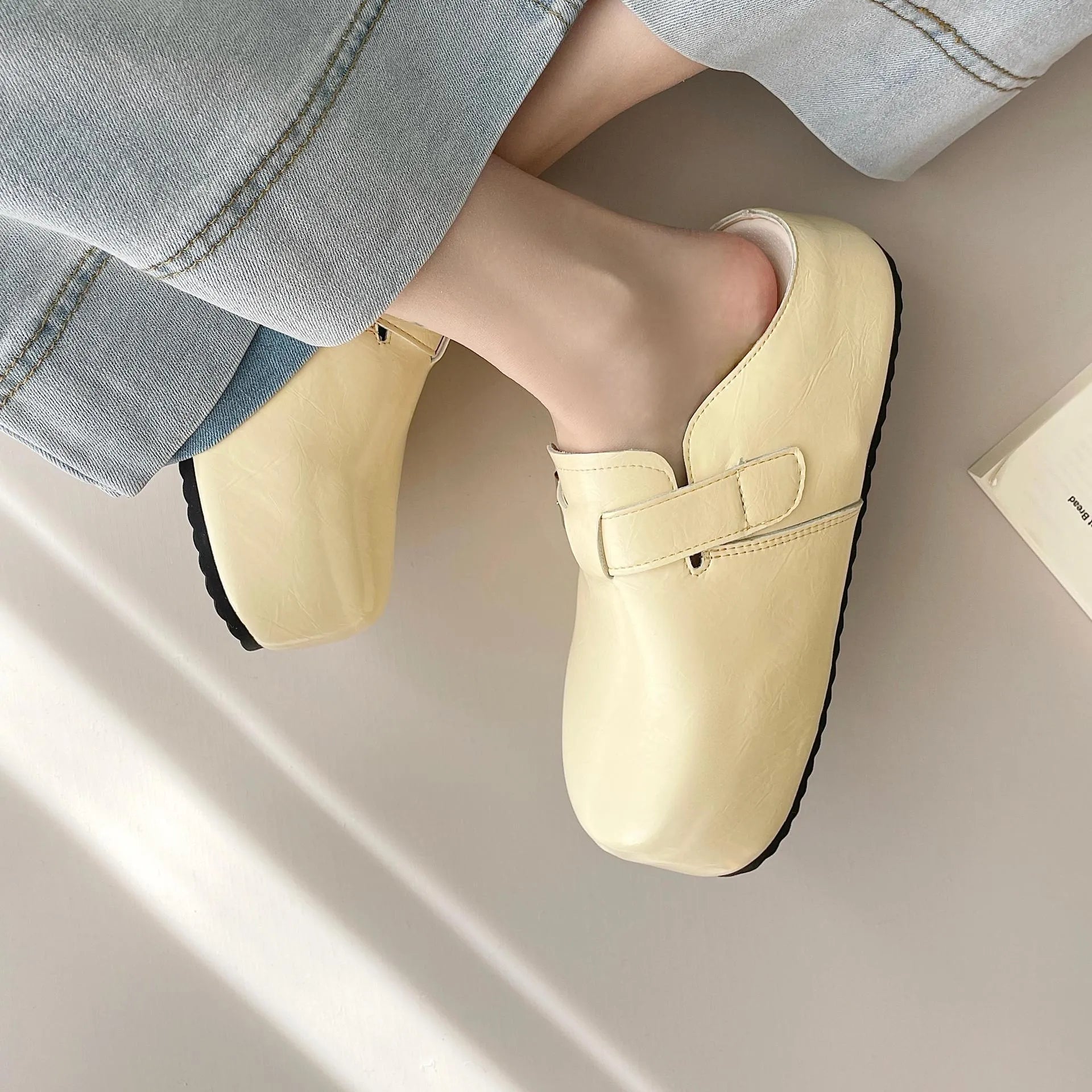 Flat buckle casual sneakers in yellow, black, silver, and creamy-white colours with rounded toe shape