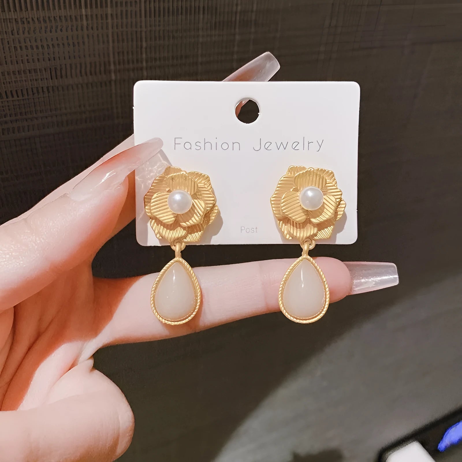 Gold-toned stud earrings with Hong Kong style ice flower design and centre opal stone