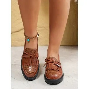 Brown women's loafer with a bow detail on the vamp, made from artificial PU leather.