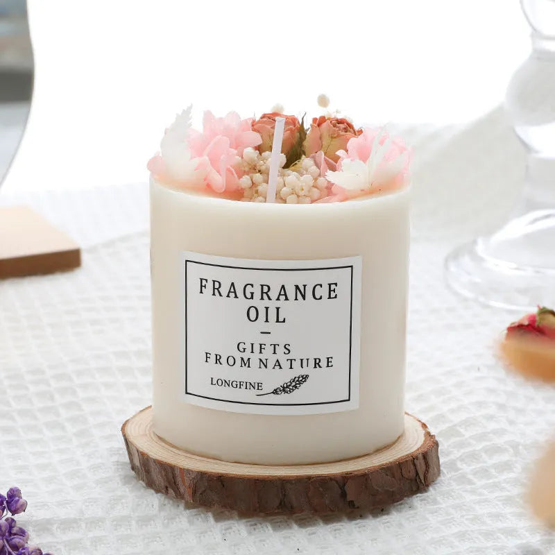 Aromatherapy candle decorated with dried flowers on top, shown in gift box packaging with a wood base.
