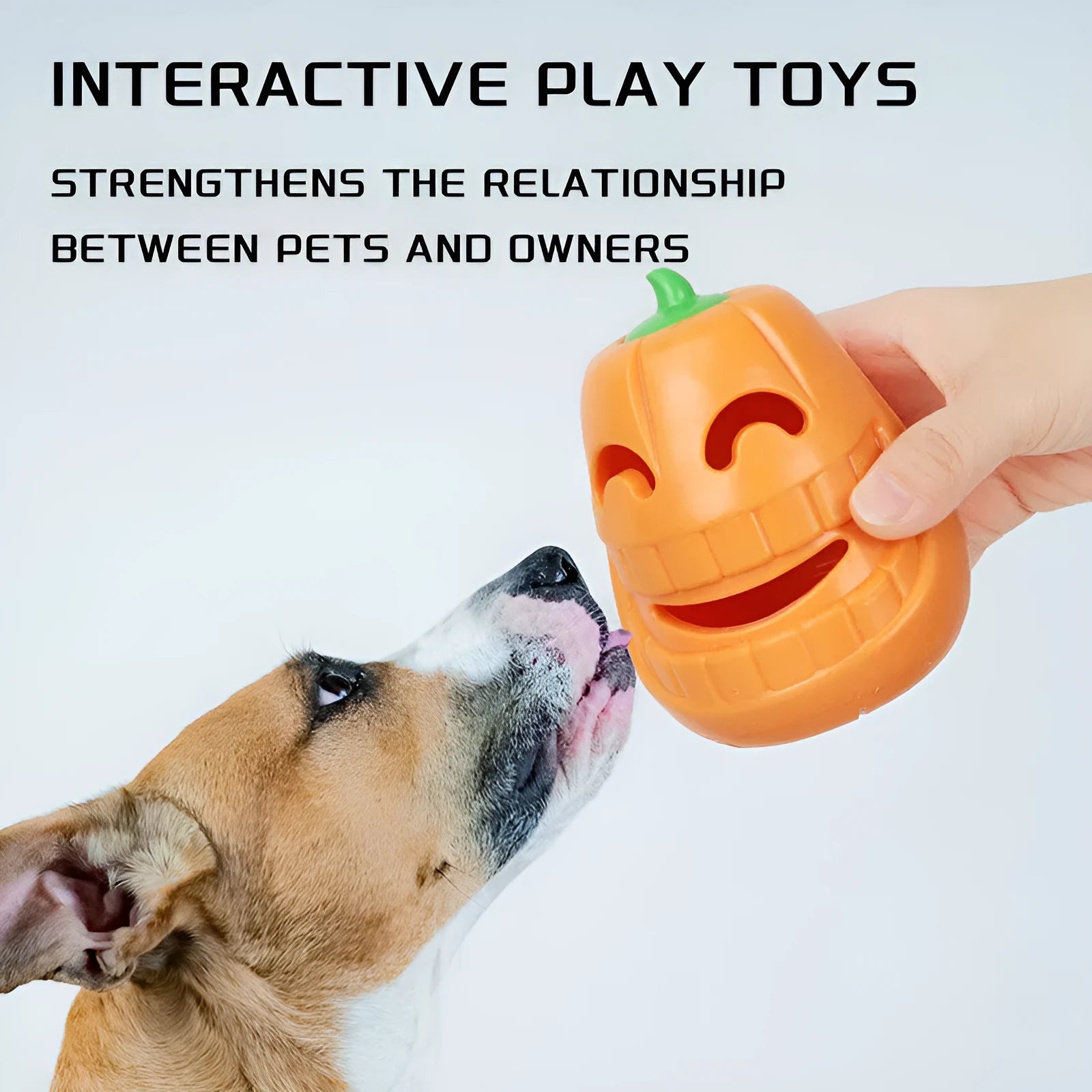 Orange Halloween pumpkin-shaped rubber dog chew toy with a treat-dispensing funnel hole.