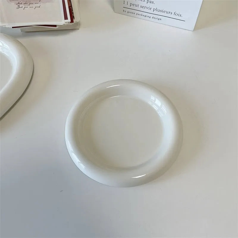 White ceramic chubby toot plate with doodle design, shown in bear and round styles.