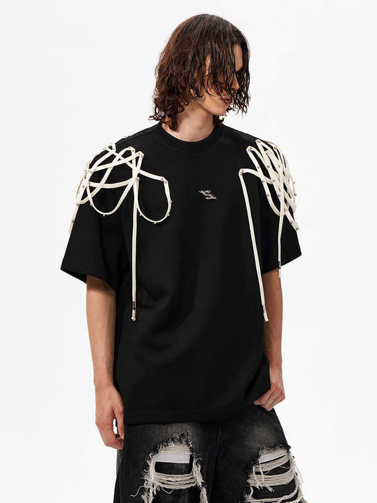 Black loose fit T-shirt with padded shoulders and decorative rivet ribbon detail on a short sleeve.