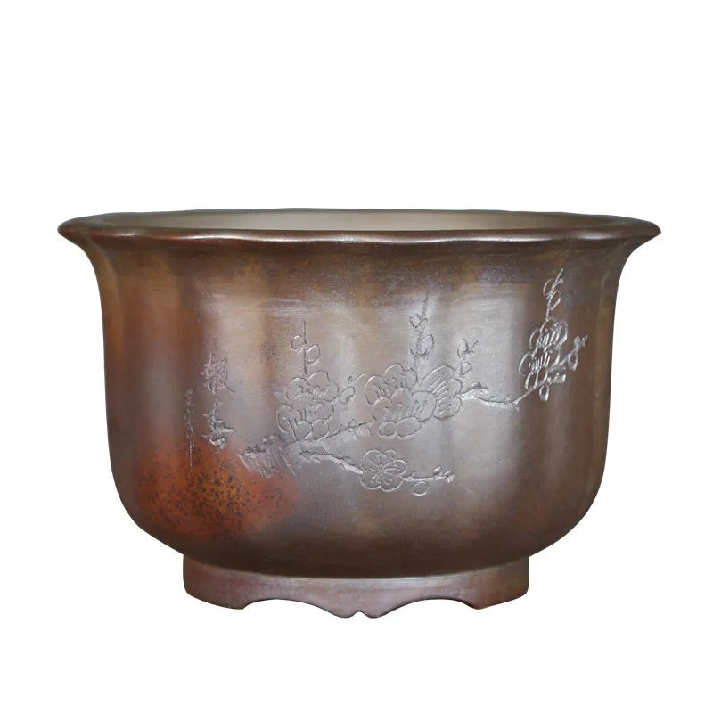 Indoor antique carved ceramic flower pot in purple sand clay with old pile texture
