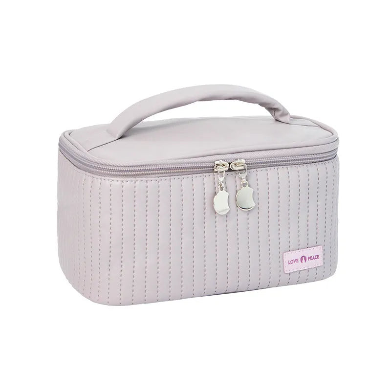 Open-top cake shaped makeup bag in solid colour PU leather, shown in a light blue colour variant.