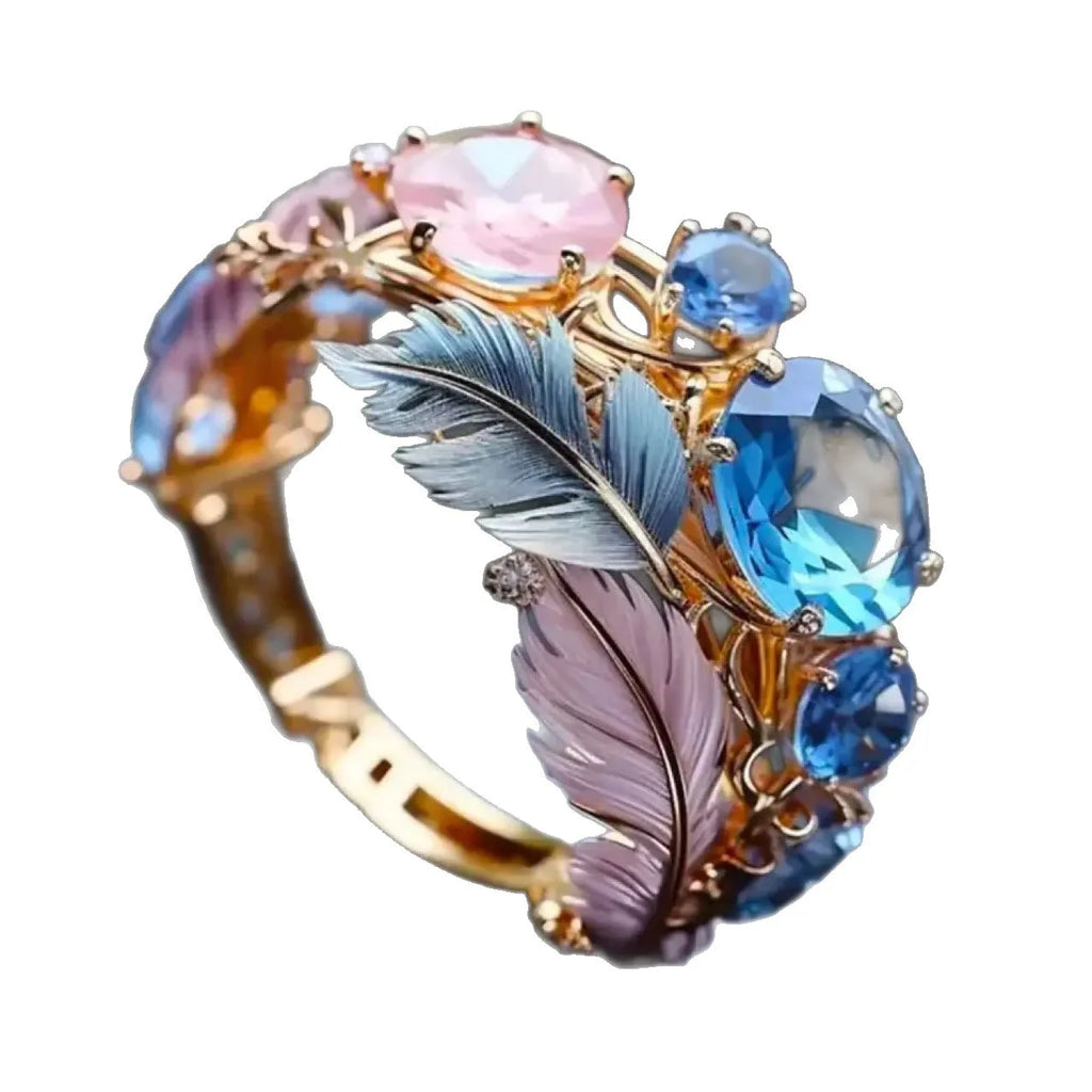 Gold brass ring with embossed feather design and zircon stone accents