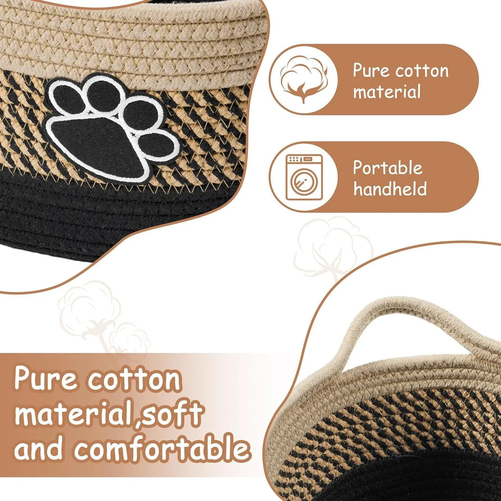 Light beige handmade cotton rope storage basket with wooden handle on a table.