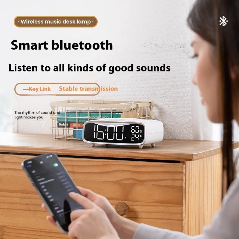 White wireless charger Bluetooth speaker with night light showing charging surface and control buttons