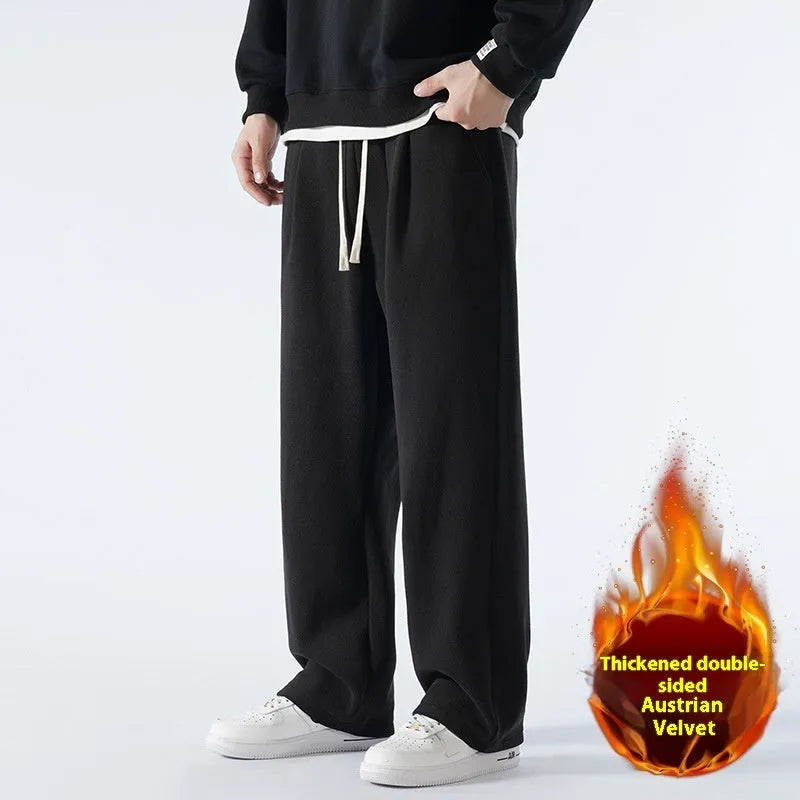 Men's thick apricot coloured fleece-lined loose fit casual sports trousers on a hanger.