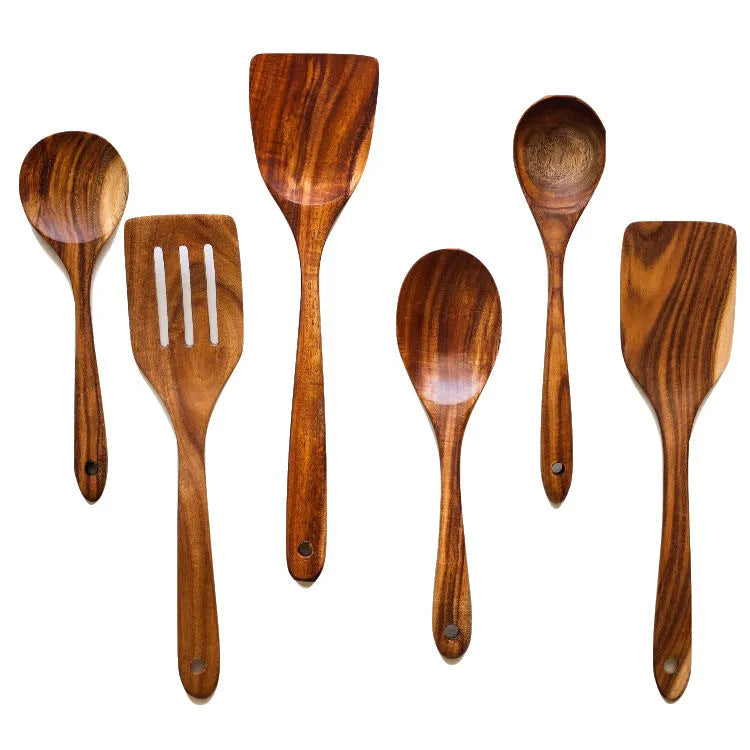 A set of seven wooden cooking utensils including spoons and spatulas on a kitchen counter.