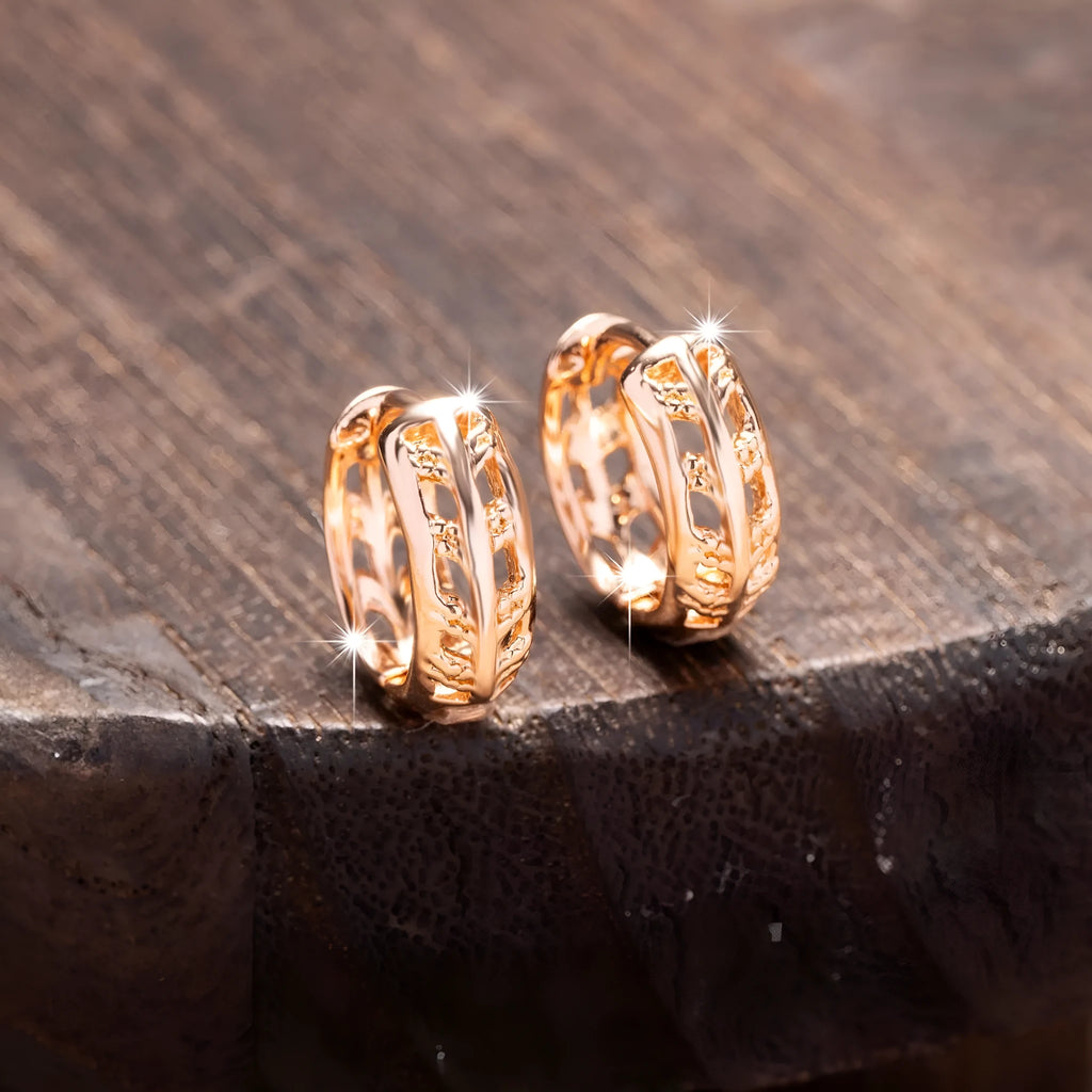 Rose gold hollow leaf earrings with a heart detail, made from copper.