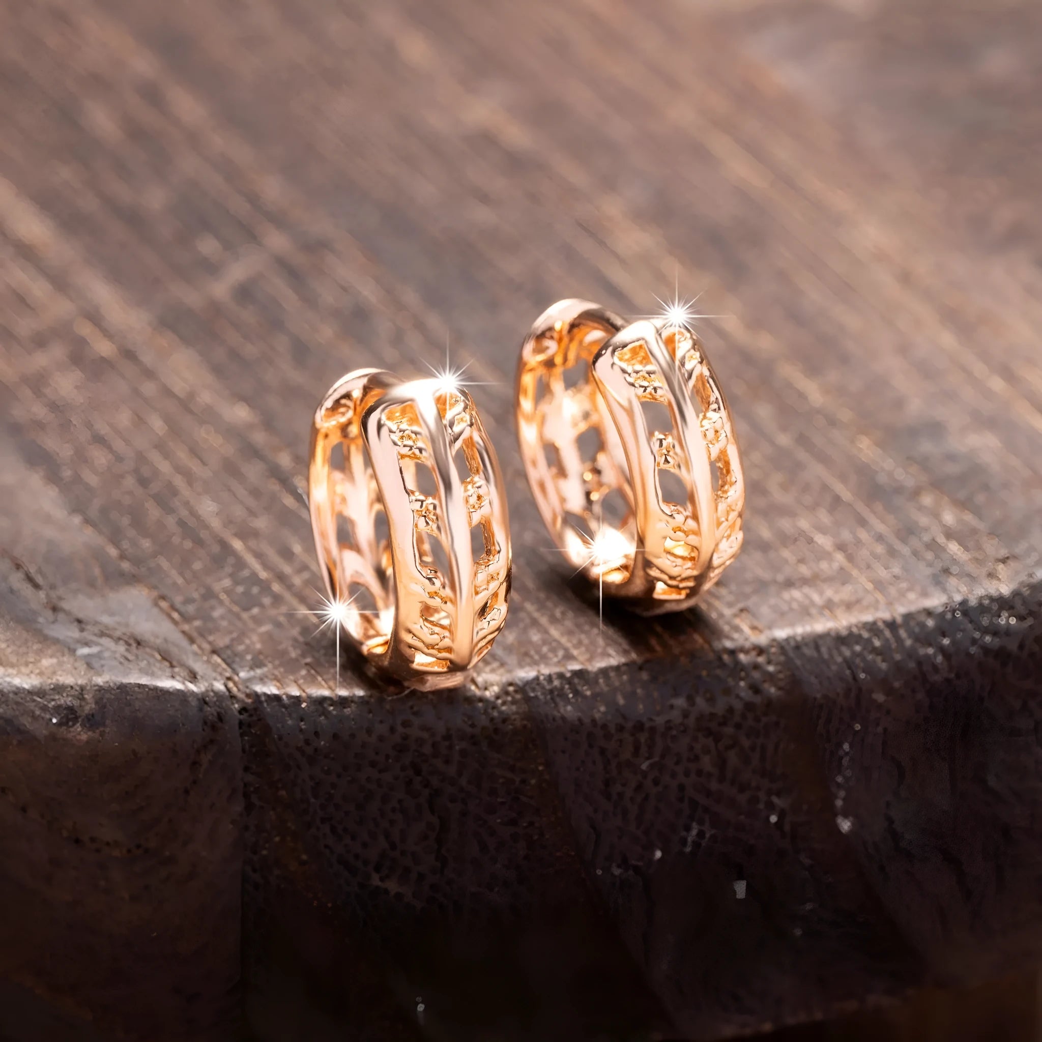 Rose gold hollow leaf earrings with a heart detail, made from copper.