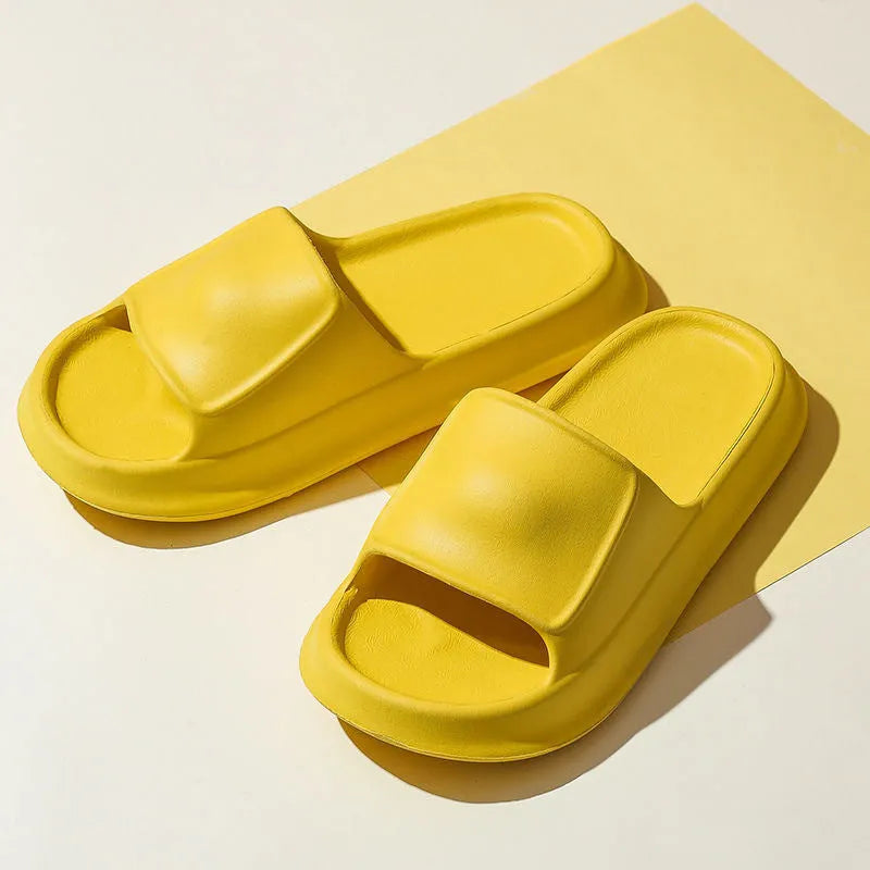Thick-soled EVA flip-flop slippers in multiple colours on a bathroom floor, showing non-slip sole texture.