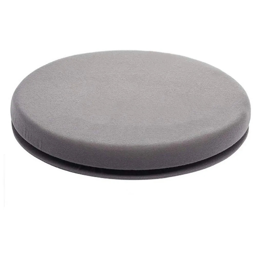 Circular grey rotating car seat cushion with plush fabric on a car seat.