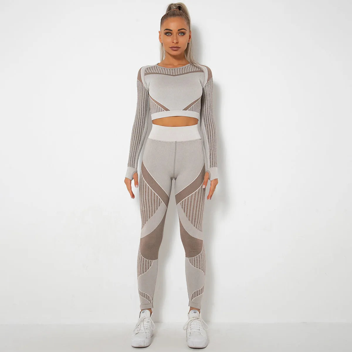 Woman wearing a long-sleeved seamless knitted yoga wearsuit in a stripe pattern, demonstrating a yoga pose.